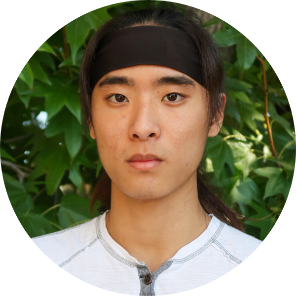 Man with black headband and white shirt looking at the camera.