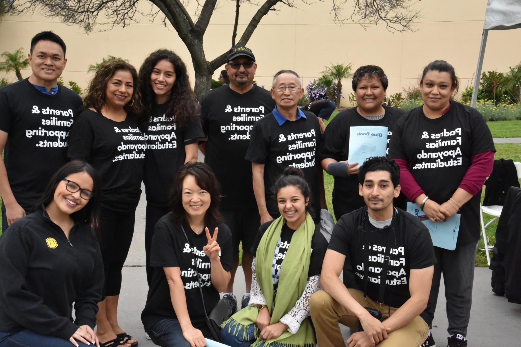 Parents wearing matching t-shirts and smiling